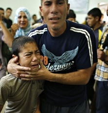 A Palestinian boy cries as compound is evacuated